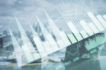 Double exposure of financial chart drawings and desk with open notebook background. Concept of forex market