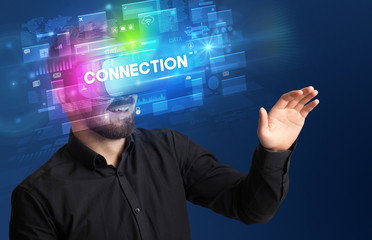 Businessman looking through Virtual Reality glasses with CONNECTION inscription, innovative security concept