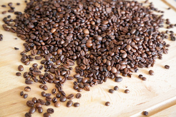 Coffee grains on wooden table, with natural light