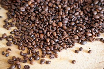 Coffee grains on wooden table, with natural light