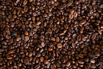 Coffee grains on wooden table, with natural light