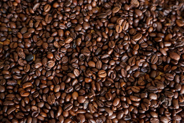 Coffee grains on wooden table, with natural light