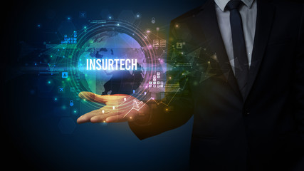 Fototapeta premium Elegant hand holding INSURTECH inscription, digital technology concept