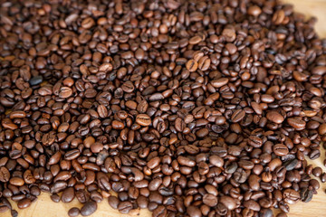 Coffee grains on wooden table, with natural light