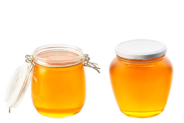 two large jars of honey isolated on white background.