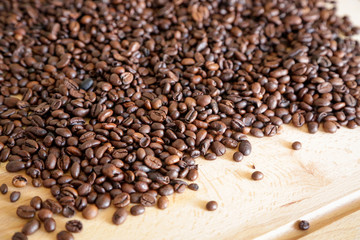 Coffee grains on wooden table, with natural light