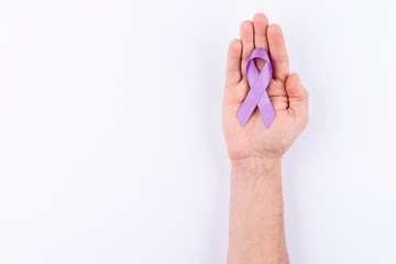 Blue violet ribbon over palm. White background.