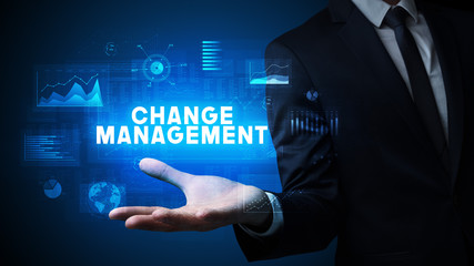 Hand of Businessman holding CHANGE MANAGEMENT inscription, business success concept