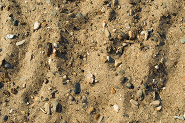 Sand on the beach with pebbles