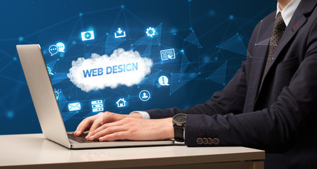 Fototapeta na wymiar Businessman working on laptop with WEB DESIGN inscription, modern technology concept