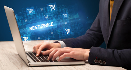 Businessman working on laptop with BEST PRICE inscription, online shopping concept