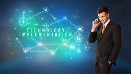 Businessman in front of cloud service icons with TECHNOLOGY IMPLEMENTATION inscription, modern technology concept