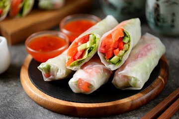 Spring rolls with salmon, cucumber, pepper, tomato and lettuce. Organic food