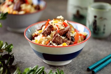 Fried rice with beef meat, corn, eggplant, carrots, garlic, bell pepper and garlic.