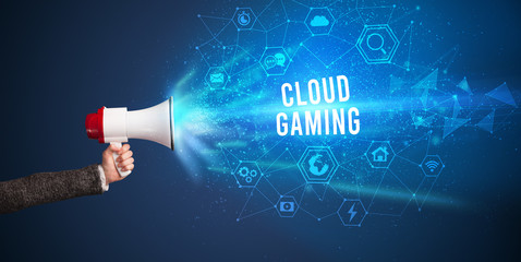 Young woman shouting in megaphone with CLOUD GAMING inscription, Modern technology announcement concept