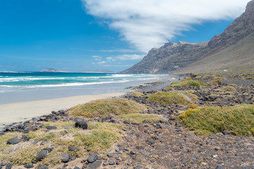 View of Famara beach on the island of Lanzarote, the best place to surf in Lanzarote