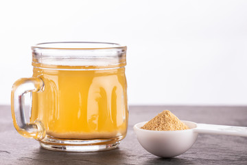 Maca root health drink in a glass with powdered - Lepidium meyenii.