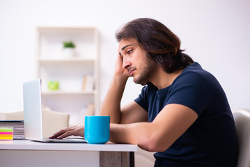 Young man employee working from house