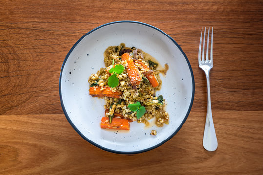 Grain Salad With Freekeh, Roasted Carrots And Orange Dressing, Sprinkled With Hazelnuts And Coriander Or Cilantro, Flat Lay