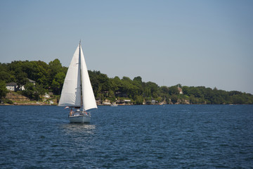Fototapeta na wymiar A sail boat on a river on a sunny, summers day