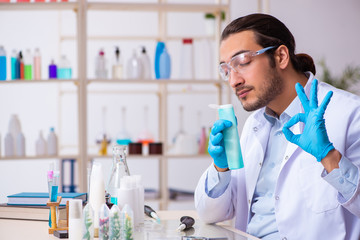 Young male chemist working in the lab