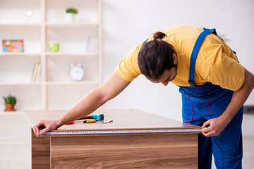 Young male carpenter working indoors