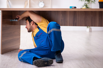 Young male carpenter working indoors