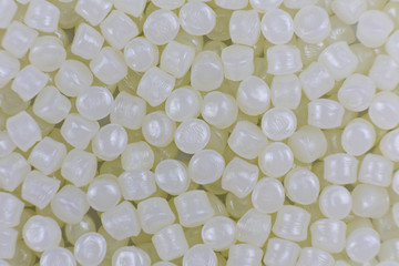 White plastic beads on wood  background, Polymers bead or polymer resin, polymer pallet, Product...