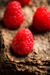 Ripe raspberry on the wooden plank. Selective focus. Shallow depth of field.
