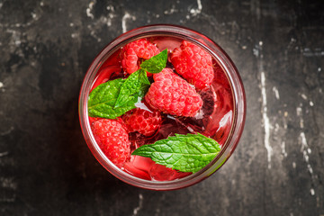 Raspberry and mint cocktail in glass on the rustic background. Selective focus. Shallow depth of field.