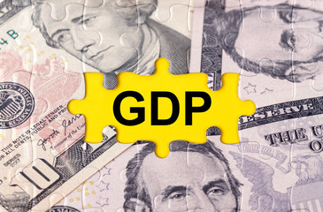 Puzzle with the image of dollars in the center of the inscription -GDP