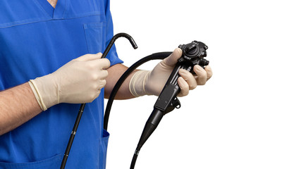 Male doctor gastroenterologist holding an endoscope with his hands in protective gloves.