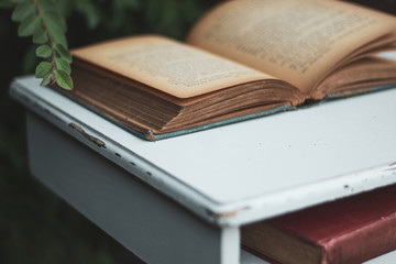 Pair of Vintage Books on white vintage table outside - Books by Agatha Christie, one opened one on shelf