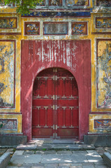 Fototapeta na wymiar Painted door at ancient ruins in Hue, Vietnam