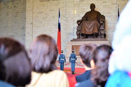 Tourists watch the changing of the guards at the Chiang Kai Shek Memorial Hall in Taiwan