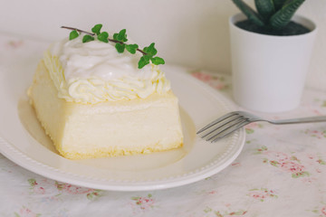 Fresh baked vanilla sponge cake frosting with dairy whipped cream topping with young coconut pudding sauce so sweet and delicious. Exotic asian style dessert. Homemade bakery concept for cafe.