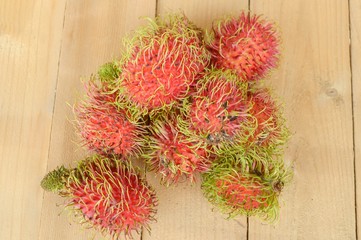 rambutan fruit on wood plank