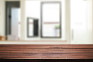 Wooden desk space and blurry background of home window for product display montage.