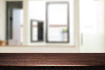 Wooden desk space and blurry background of home window for product display montage.