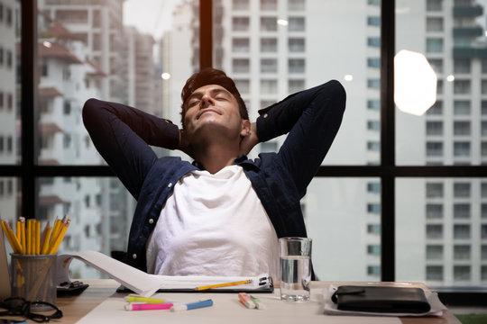 Business people or freelance sitting and thinking and relaxing while working in office, stretch the arms and sleeping action