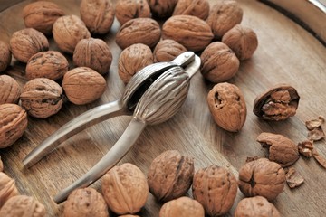 Nutcracker and Nuts.Walnuts close-up on wooden background. Tool for nuts. Delicious and healthy nuts.Keto diet ingredient