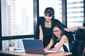 Business Lady officers discussing and working or using computer on desk in office with colleagues...