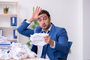 Businessman rejecting new ideas with lots of papers