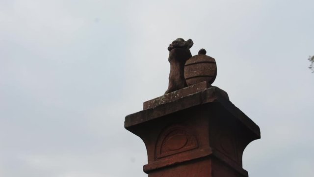 Statue Of Ugly Wild Big With Shield On Top Of Post Gimbal Orbit Shot, Buedingen, Germany