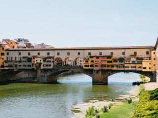 Fototapeta na wymiar Ponte Vecchio, medieval stone closed-spandrel segmental arch bridge over the Arno River, in Florence, Italy