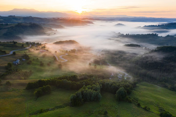 Drone view of beautiful summer mountains covered with mist.