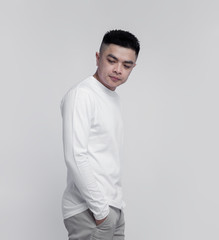 Young handsome man posing wearing white long sleeve t shirt with mockup concept