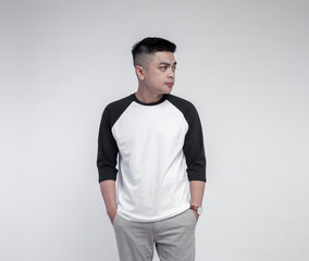 Fototapeta premium Man in black white raglan sleeve t-shirt isolated on background