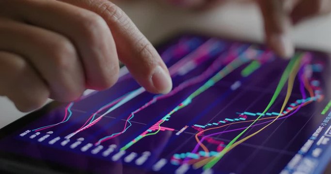 Man use of tablet computer with stock market data