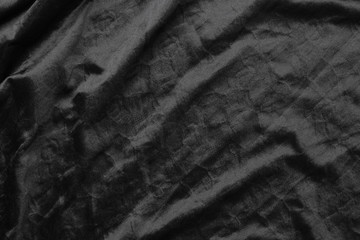 Abstract black fabric cloth texture background or liquid wave or wavy folds.